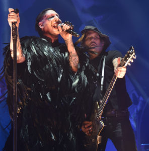 Marilyn Manson Singing in Black Feather Outfit With Johnny Depp Playing Guitar Wearing Hat