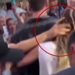 Fan Grabbing Miley Cyrus with red circle highligting moment