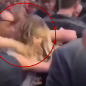 Fan Grabbing Miley Cyrus with red circle highligting moment