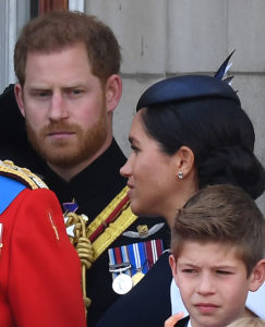 Prince Harry in Uniform wth Meghan Markle turning her head towards him
