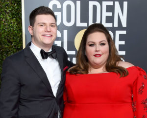 Hal Rosenfeld Wearing A Tuxedo Standig With Chrissy Metz Wearing A Red Gown